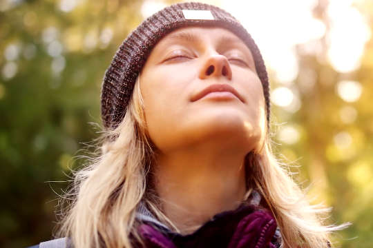 Everyday Shabbat and Mindfulness young woman with her eyes closed, face up to the sky